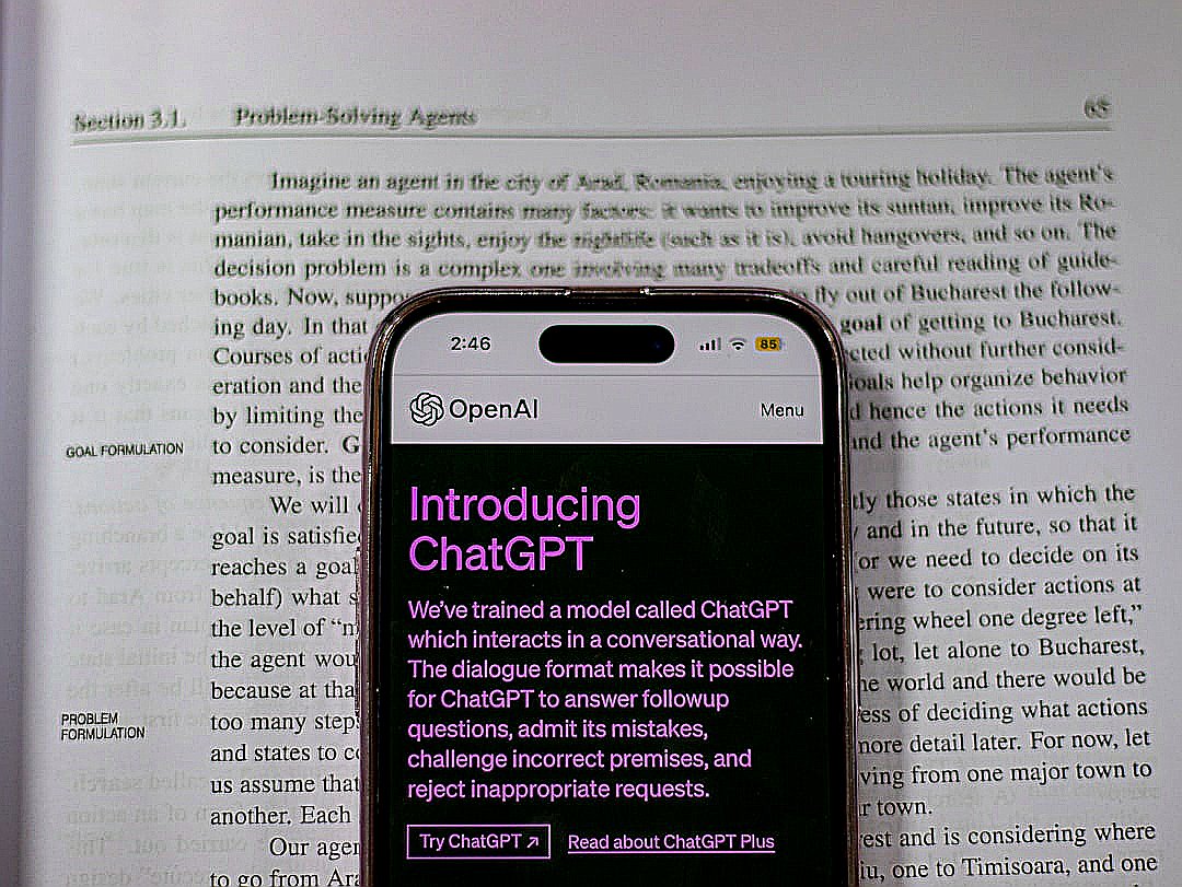 a cell phone sitting on top of an open book