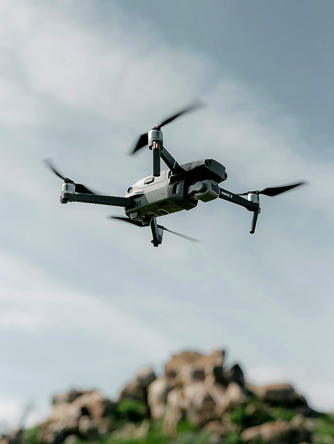 gray quadcopter flying