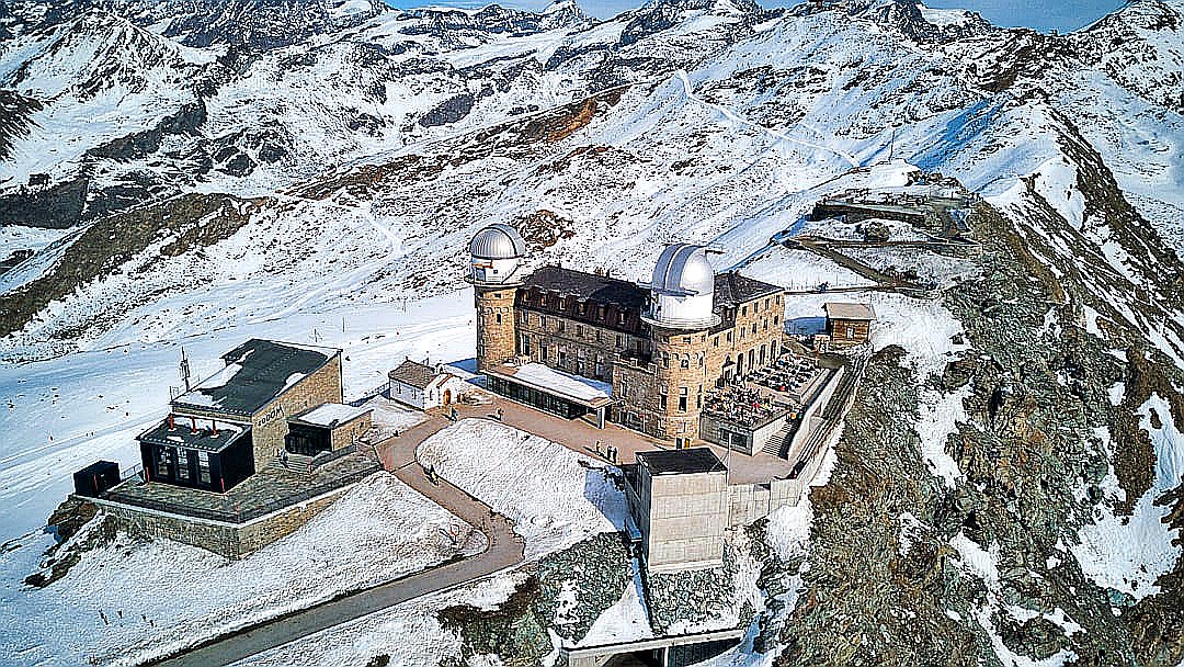 an aerial view of a castle in the mountains