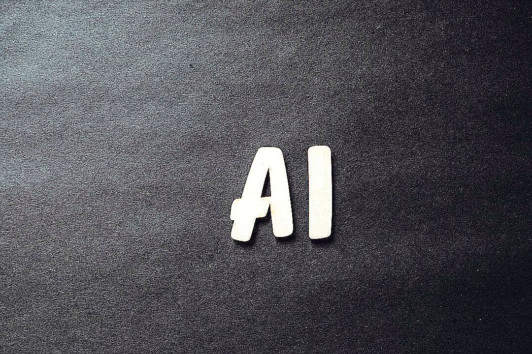 the word ai spelled in white letters on a black surface