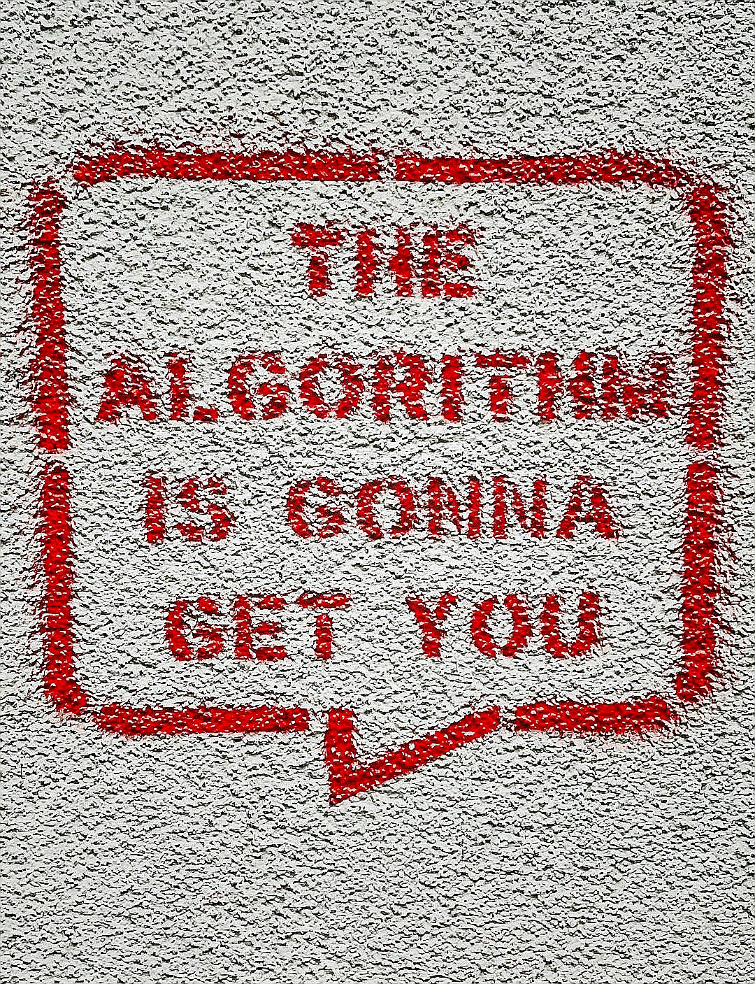 a red and white sign on a white wall