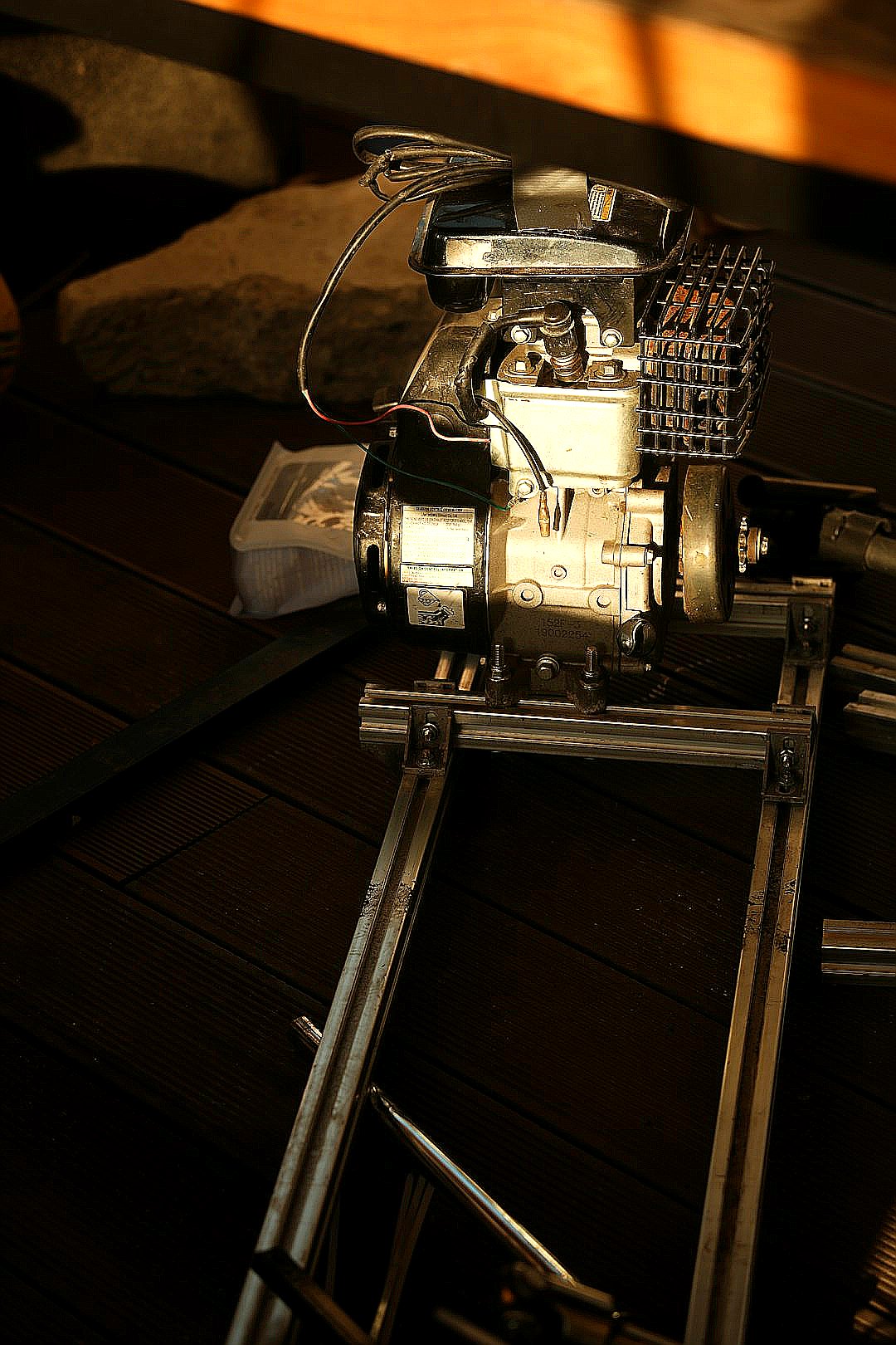 A small engine sits on a metal frame.