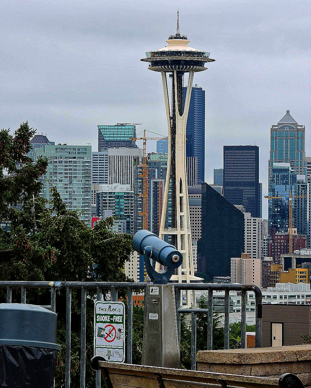 a metal tower with Space Needle in the background