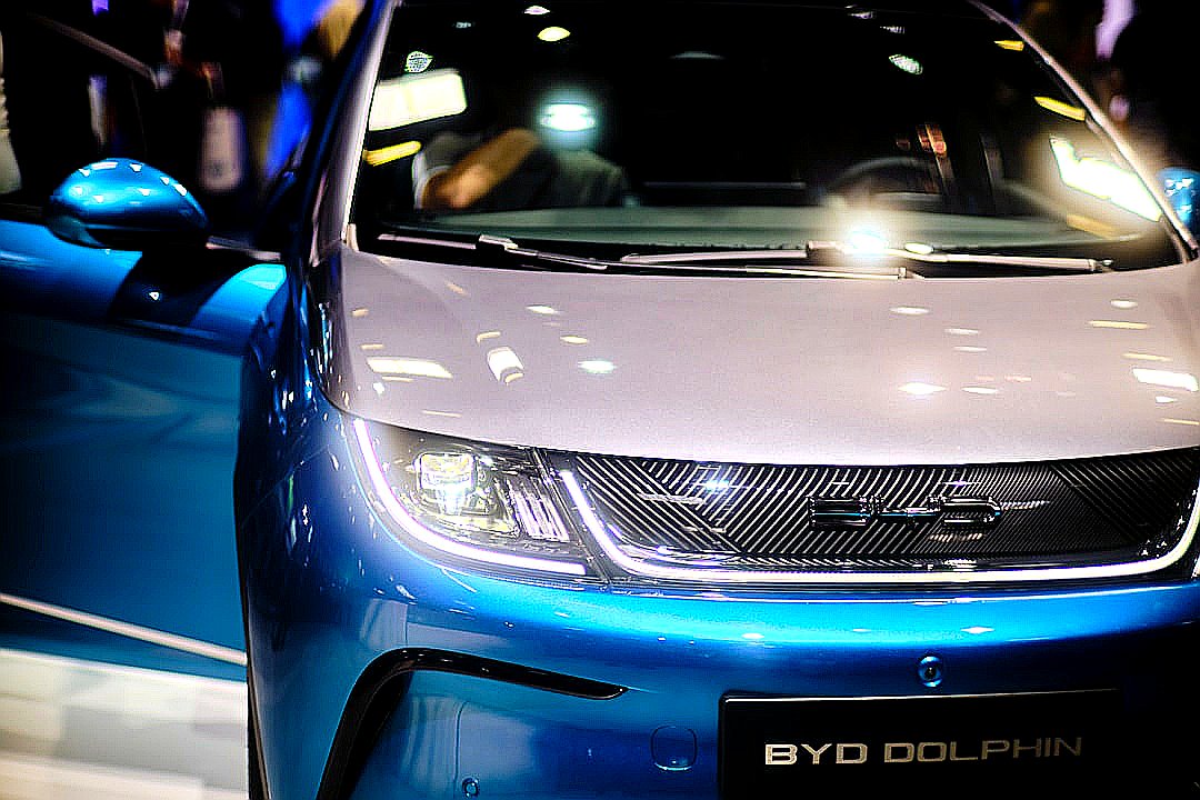 a close up of the front of a blue and white car