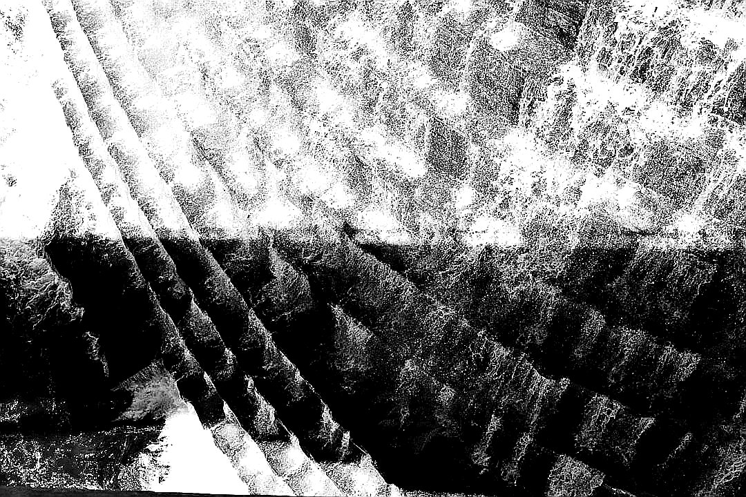 Abstract black and white pattern with textured lines.