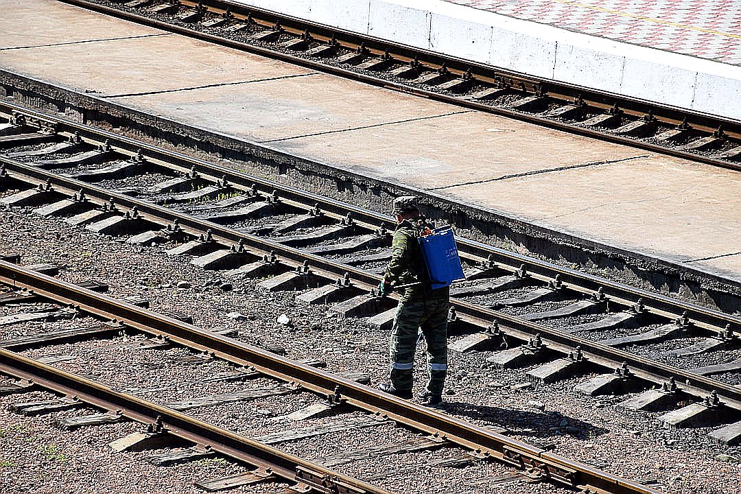 a person with a backpack standing on a train track