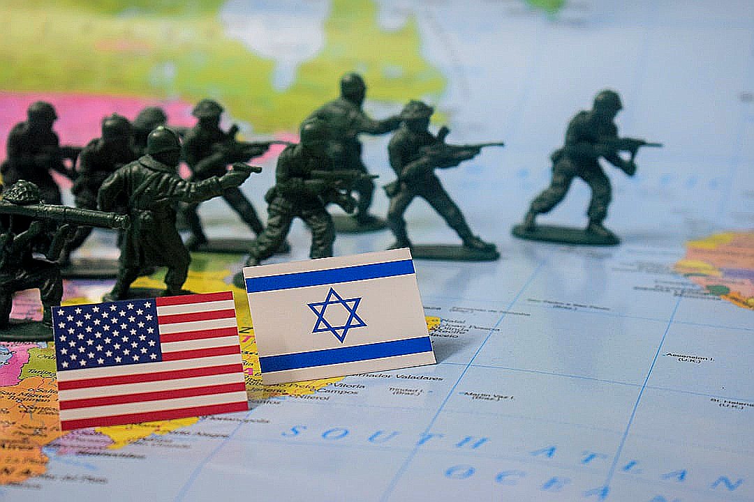 Toy soldiers stand near american and israeli flags on map