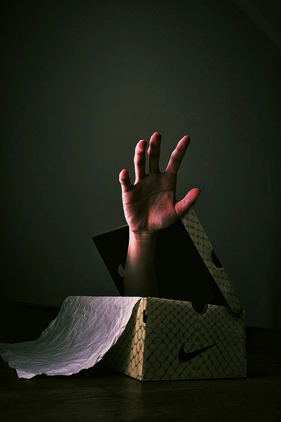 human hand in shoe box