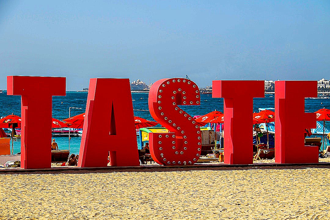 red and white polka dot arch near body of water during daytime