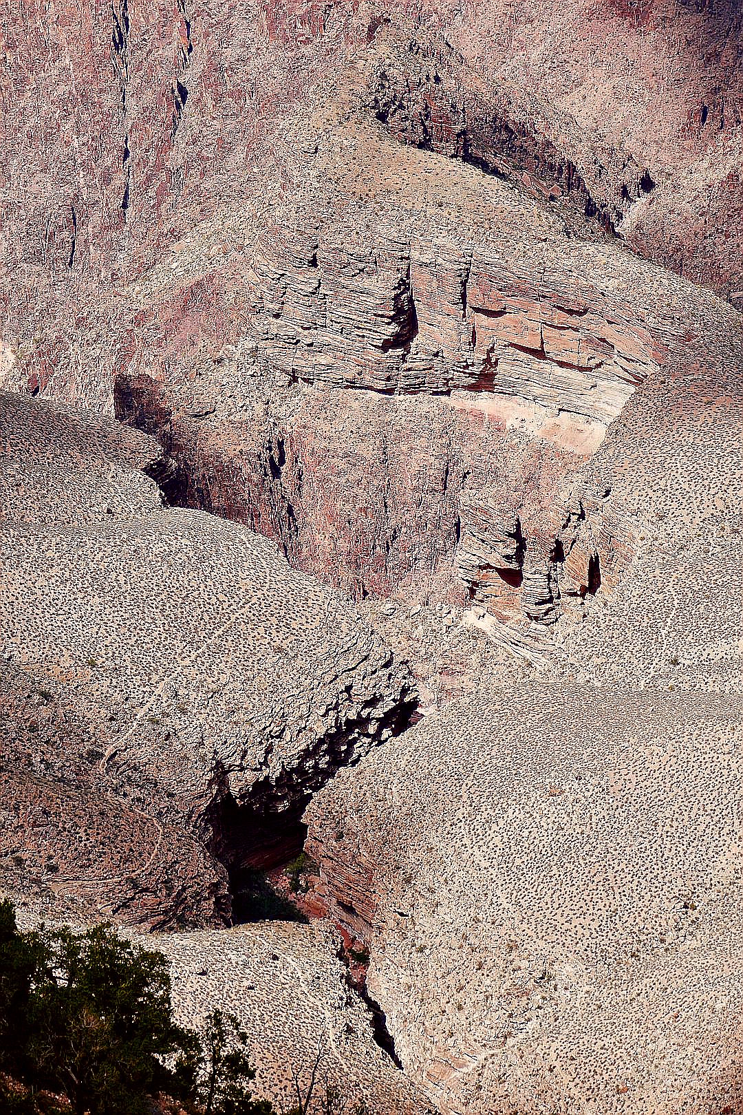 A rocky mountain with a small hole in the middle of it