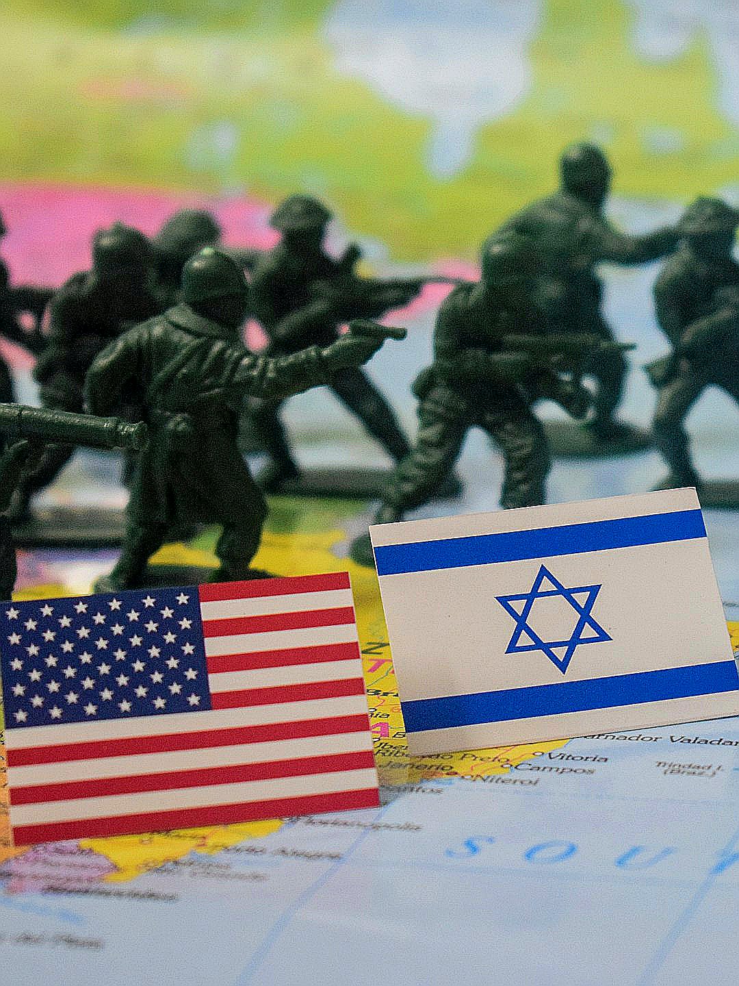 Toy soldiers and flags of usa and israel on map