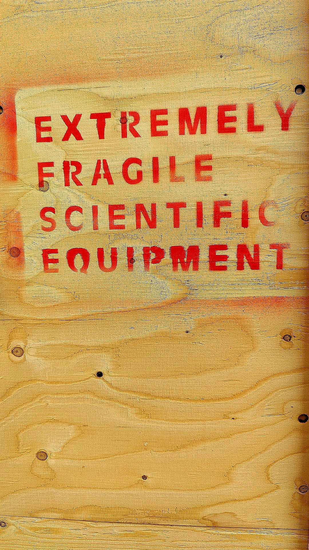 A close up of a sign on a wooden wall