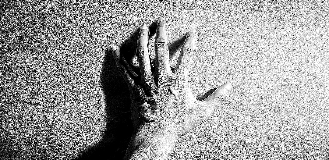 left human hand in grayscale photography