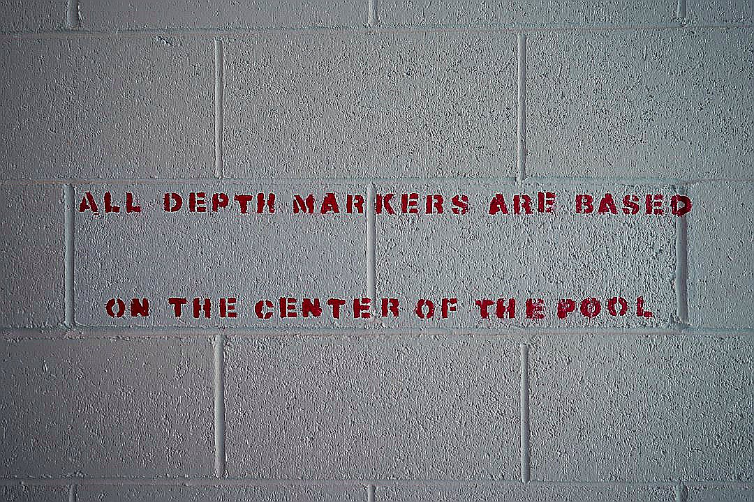 a white brick wall with red writing on it