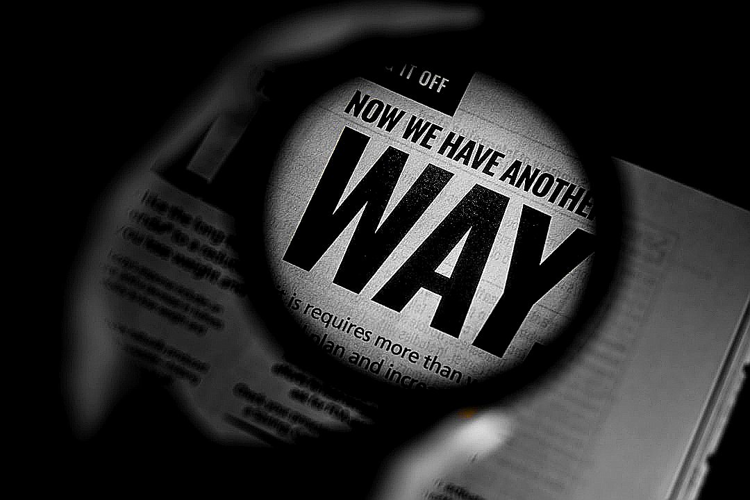 a magnifying glass over a newspaper with the words now we have another way