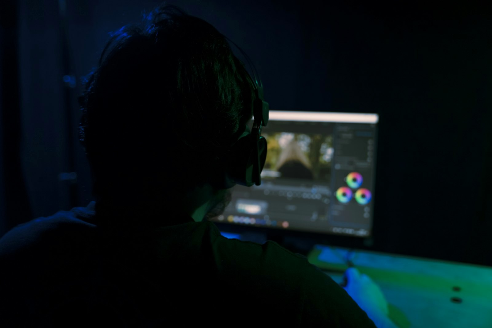 a man sitting in front of a computer monitor