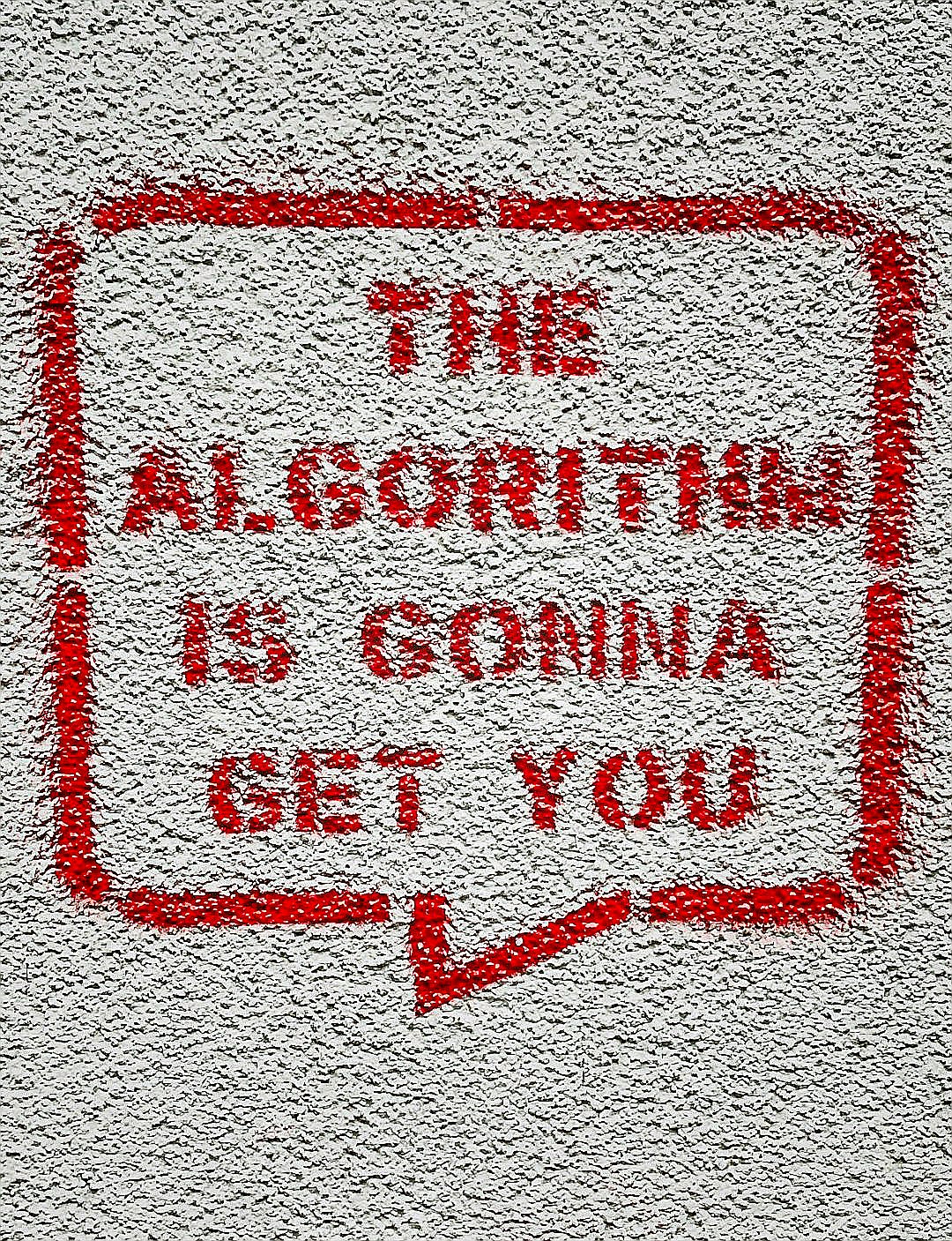a red and white sign on a white wall