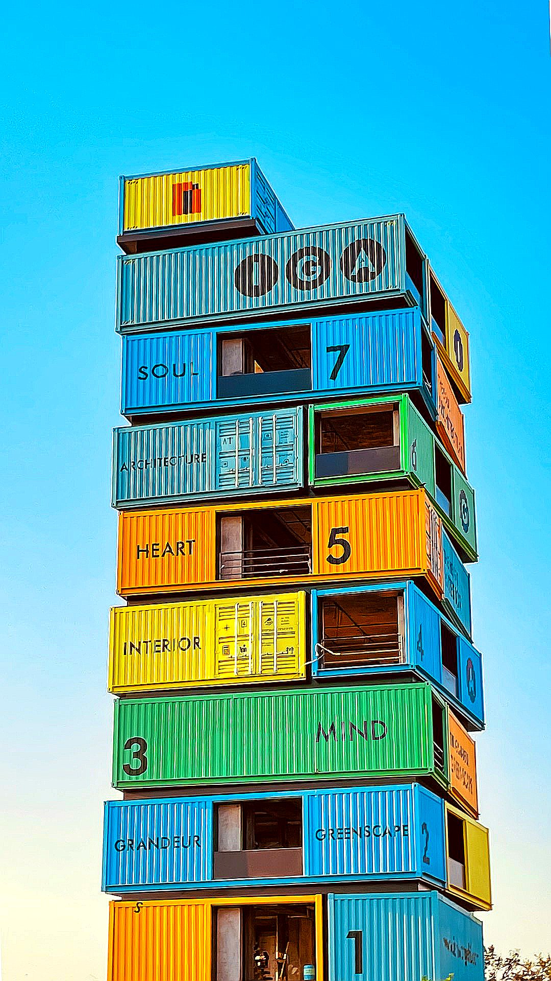a tall multi - colored building with lots of windows